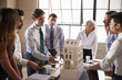 © Monkey Business - Architects discussing the scale model of a building