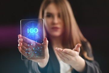 The concept of business, technology, the Internet and the network. A young entrepreneur working on a virtual screen of the future and sees the inscription: ICO