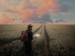 © Fran Mart - Man walking in a field at sunset