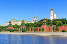 Moscow Kremlin On A Moskva River Background Against Blue Sky In Sunny Summer Morning