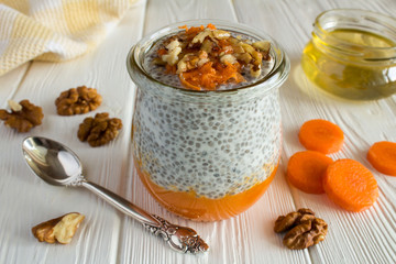 Wall Mural - Pudding with chia,carrot,walnuts  and honey on the white  wooden background