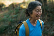 © Rob and Julia Campbell/Stocksy - Content mature hiking woman portraits in the woods