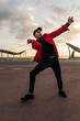 © Bonninstudio/Stocksy - Young man dancing on the street.