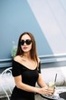 © nazariykarkhut - Young pretty girl sitting in a cafe on the street and drinking cooled drink