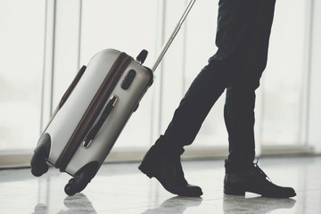 Businessman Running with Luggage in Airport