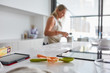 © Miquel Llonch/Stocksy - Woman baking homemade cookies in her kitchen