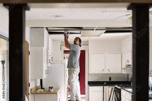 Kitchen Man Removing Drop Ceiling Tiles This Stock Photo And Kitchen Man Removing Drop Ceiling Tiles