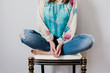 © Kelly Knox/Stocksy - casual, anonymous portrait of a woman sitting in a chair