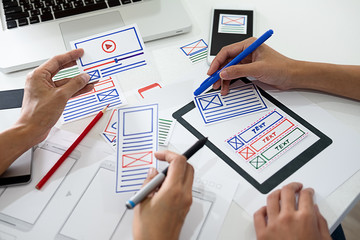 Wall Mural - creative web designer planning application and developing template layout, framework for mobile phon