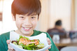 © sirikorn - Healthy lifestyle asian child showing salad smiling.
