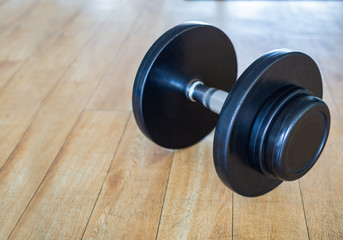 Dumbbell on wooden floor in the gym