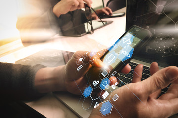 two colleagues website designer discussing data and digital tablet and computer laptop with  graphics design diagram on marble desk as concept, sun flare effect