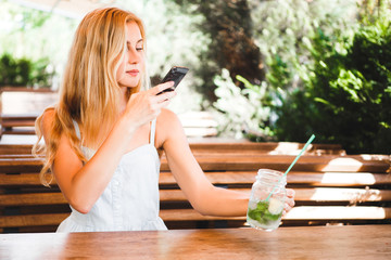 Woman taking picture of food with mobile phone