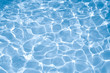 Blue water surface with bright sun light reflections, water in swimming pool background