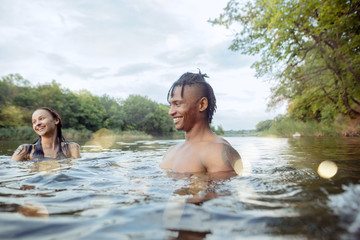 Enjoying river party with friends. Group of beautiful happy young people at the river together