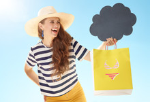 Woman With Yellow Shopping Bag With Bikini Looking At Blank Cloud Board