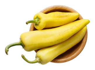 Wall Mural - Long sweet pepper in wooden bowl isolated on white. Top view