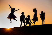 Five Children Jump At Sunset