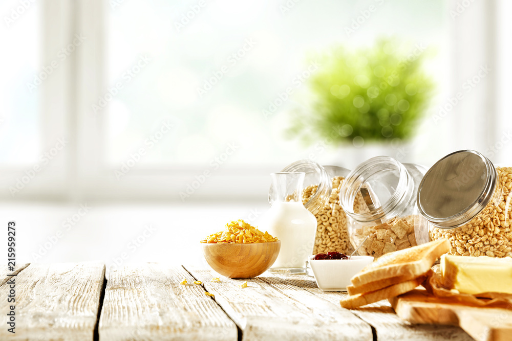 Continental breakfast and blurred background of white window with green ...