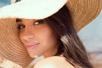 Wall Mural - portrait of attractive girl posing in straw hat