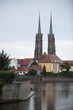 View from behind the river to the Catholic Cathedral of John the Baptist in Wroclaw on the island of Tumski in Poland.
