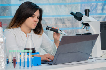 Poster - Young female technician in the quality control laboratory of wine quality inspection