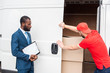 © LIGHTFIELD STUDIOS - african american businessman with notepad looking at caucasian delivery man closing van with cargo