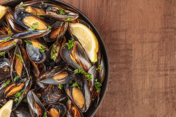 Wall Mural - Skillet of marinara mussels on rustic background with copy space