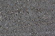 © EVGENII - smooth grey asphalt pavement texture. heterogeneous structure of poor quality