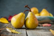 Autumn Harvest Concept - Fresh Ripe Organic Yellow Pears With Water Drops On Rustic Wooden Table, Dark Stone Background. Vegetarian, Vegan, Healthy Diet Food. Selective Focus