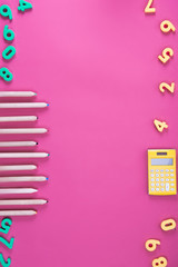 flat lay with arranged various school appliances on pink