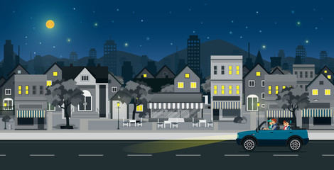 Wall Mural - Families drive on city streets at night.