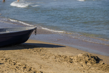 Fishing boat on the beach near the sea.