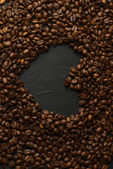 Coffee grains on a dark background. A delicious fragrant coffee of the best varieties. Coffee texture. Coffee beans background.Heart of coffee