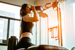 © Take Production - young fitness woman tired in gym drink   protein shake.exercising concept.fitness and healthy lifestyle