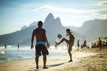 Unrecognizable Young Brazilians Play A Game Of Beach Football Keepy-uppy "altinho" On The Shore Of Ipanema Beach.