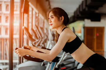 Fitness woman working out on exercise bike at the gym.exercising concept.fitness and healthy lifestyle