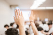 © Garun Studios - businessman raising hand during seminar. Businessman Raising Hand Up at a Conference to answer a question.
