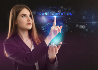 The concept of business, technology, the Internet and the network. A young entrepreneur working on a virtual screen of the future and sees the inscription: Transformation