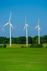 Wall Mural - windmill type wind electricity generator in the field in latvia in summer