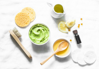 Wall Mural - honey and avocado face mask on light background, top view. beauty, youth, skin care concept. flat la
