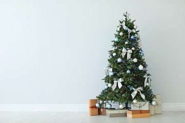 beautifully decorated christmas tree and gift boxes, indoors