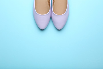 Wall Mural - Purple female shoes on blue background