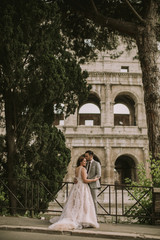 Young wedding couple by the Colosseum in Rome, Italy