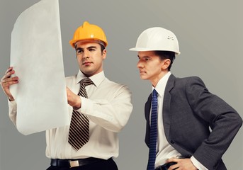 Two engineers men at construction site watching