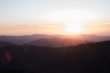 The sun rising above a mountain range in Colorado. 