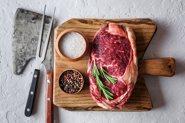 Wall Mural - Marbling ribeye steak on wooden board. Prime rib beef chop. Food photography