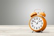 © BillionPhotos.com - Orange retro alarm clock on wooden table