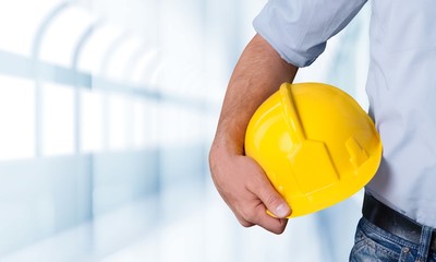 Worker man with helmet on background