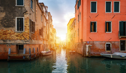 View of the street canal in Venice, Italy. Colorful facades of old Venice houses. Venice is a popular tourist destination of Europe. Venice, Italy.